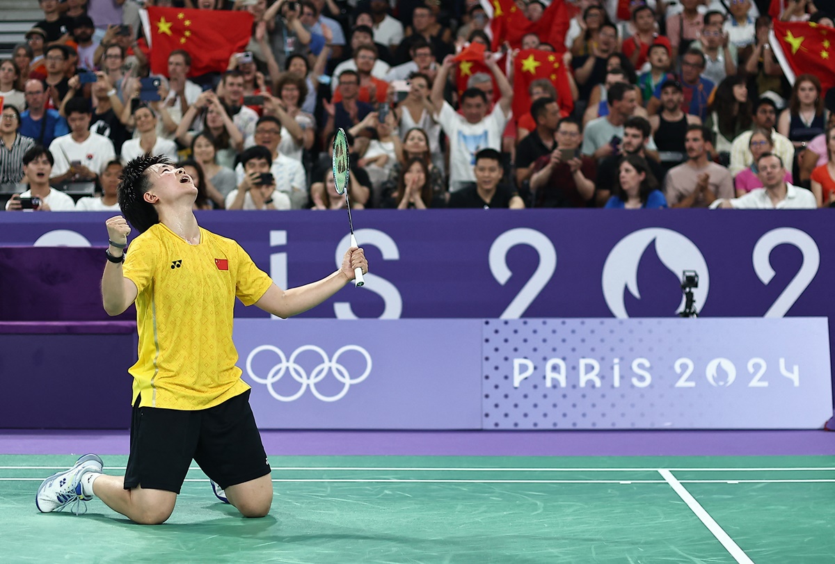 China's Bing Jiao He celebrates victory over PV Sindhu.