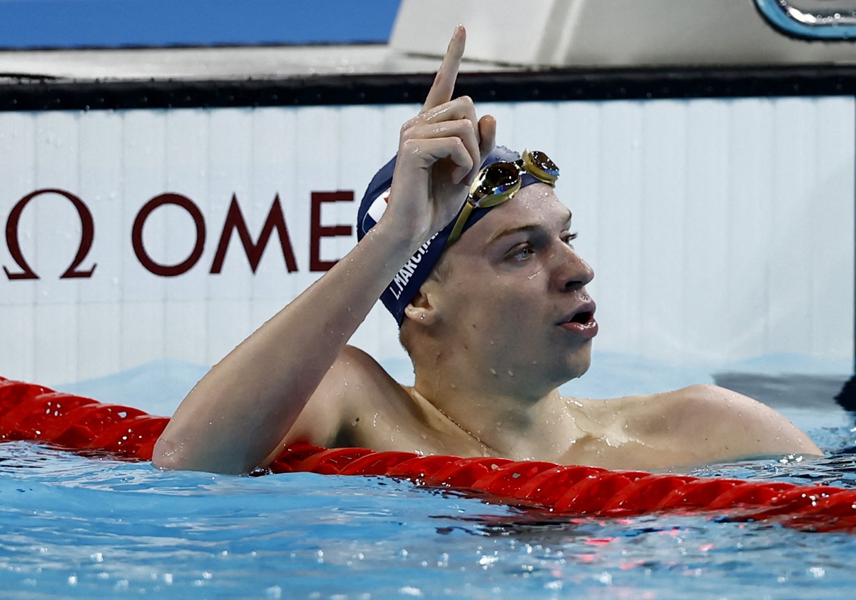 France's Leon Marchand celebrates after winning gold and setting a new Olympic record in he men's 200m Butterfly final at Paris La Defense Arena, Nanterre, on Wednesday.