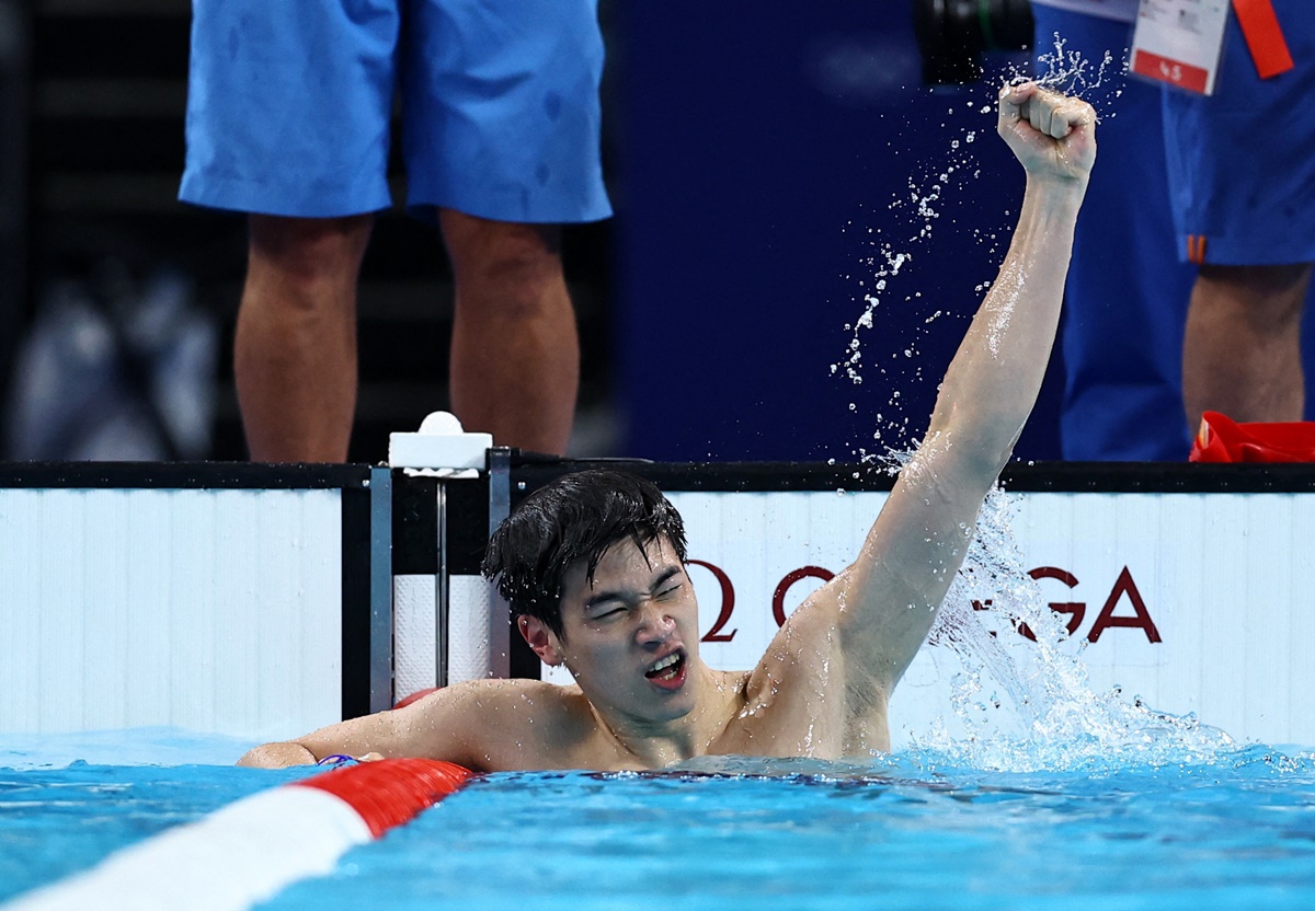 China's Zhanle Pan raises his hand in triumph after winning the men's 100m Freestyle final and establishing a World record.