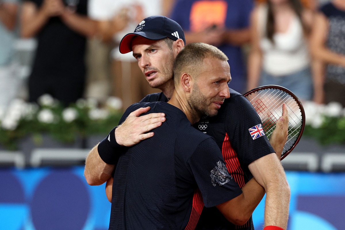 Britain's Andy Murray and Daniel Evans embrace after losing their Olympics men's doubles quarter-final to Taylor Fritz and Tommy Paul of the United States at Roland Garros Stadium, Paris, on Thursday.