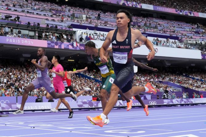 Louie Hinchliffe of Britain crosses the finish line to win heat 3 of the Men's 100m Round 1 at Stade de France, Saint-Denis, France, on Saturday