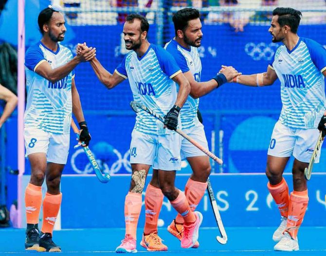 India's players celebrate a goal during the Olympics men's hockey pool match against Australia on Friday.