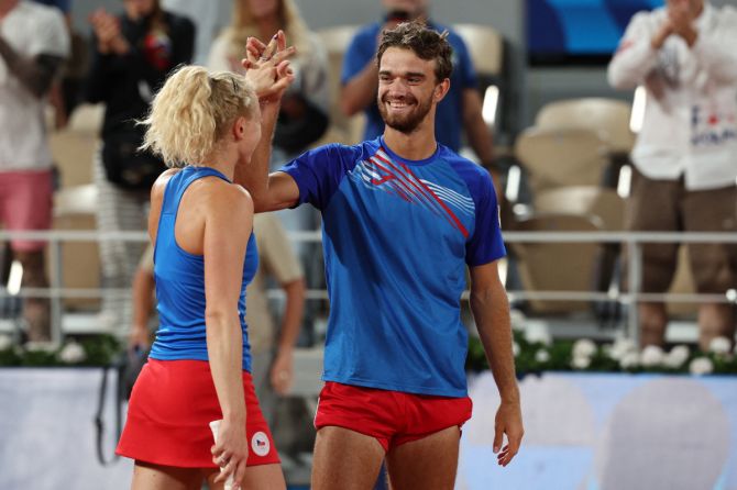 Czech Republic's Katerina Siniakova and Tomas Machac celebrate after winning gold against China's Xinyu Wang and Zhizhen Zhang in the mixed doubles at the Roland-Garros Stadium, Paris, France, at the Paris Games on Friday