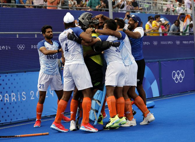  India's players celebrate their thrilling shoot-out victory over Great Britain in the Olympics men's hockey quarter-finals on Sunday