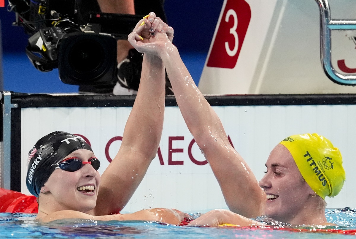 Katie Ledecky of the United States celebrates with Australia's silver medallist Ariarne Titmus after winning the Olympics women’s 800-meter freestyle final at Paris La Défense Arena on Saturday.