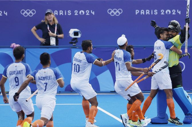 Gurjant Singh, Manpreet Singh, Sanjay, Mandeep Singh and Abhishek rush to congratulate P R Sreejesh on his fine showing in the penalty shootout.