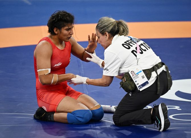India’s Nisha Dahiya receives medical attention during her bout against Sol Gum Pak of North Korea