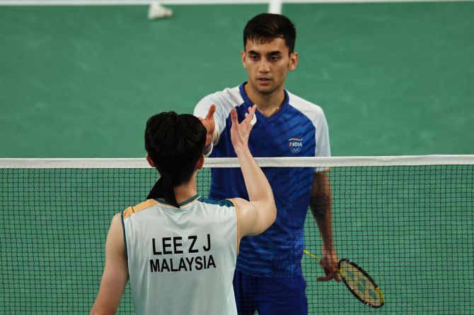 Zii Jia Lee of Malaysia is congratulated by Lakshya Sen of India after winning bronze medal at the Paris Games badminton bronze medal match on Monday