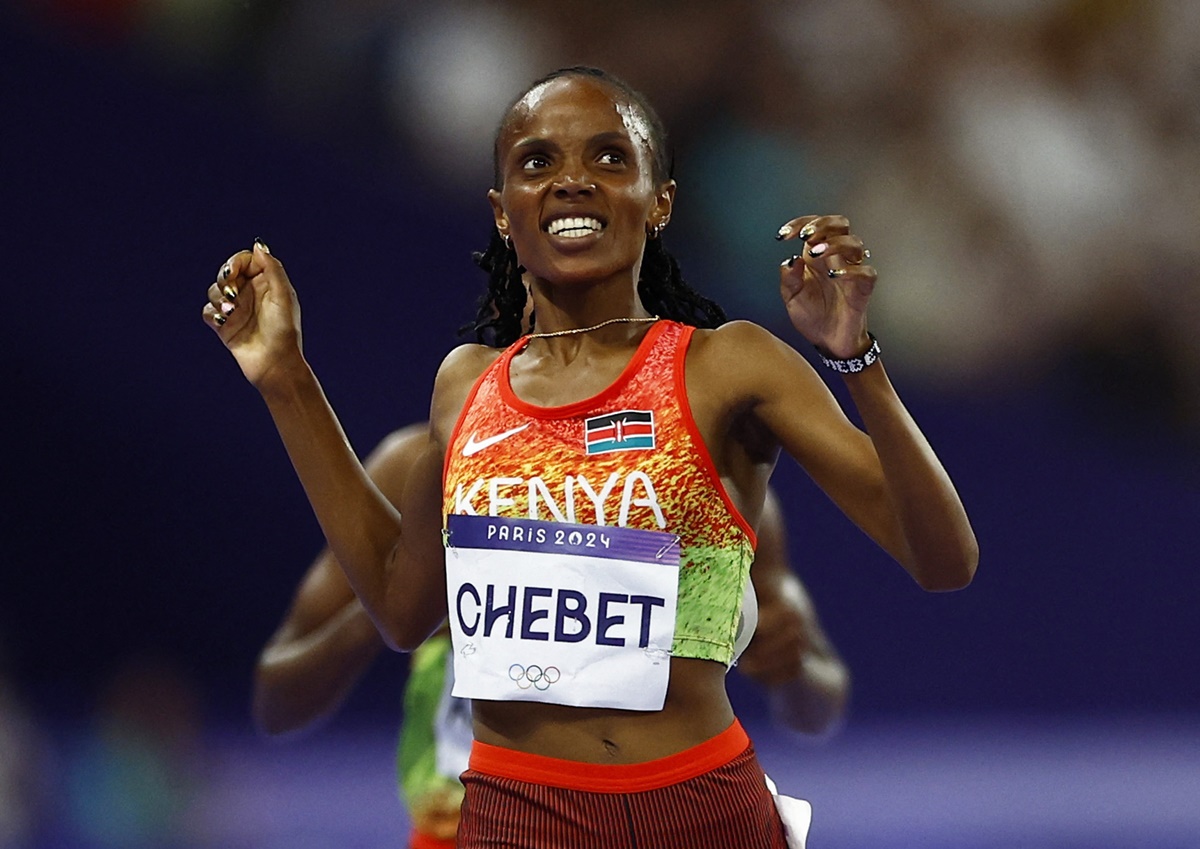 Kenya's Beatrice Chebet reacts as she crosses the line to win gold in the women's 5000 metres.