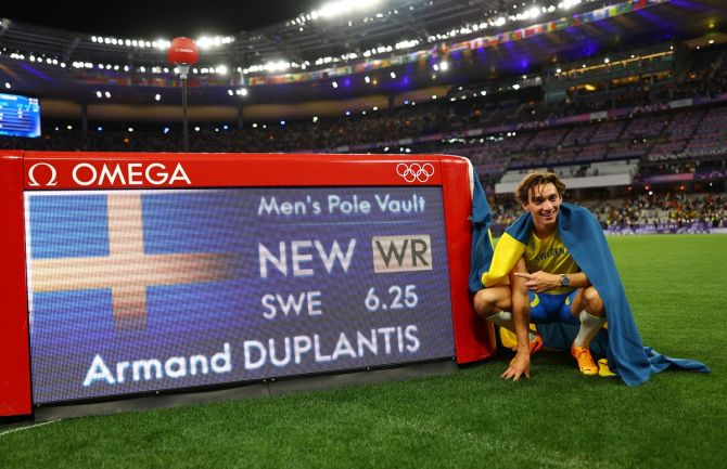 Armand Duplantis celebrates alongside a time board after winning gold and establishing a World record. 