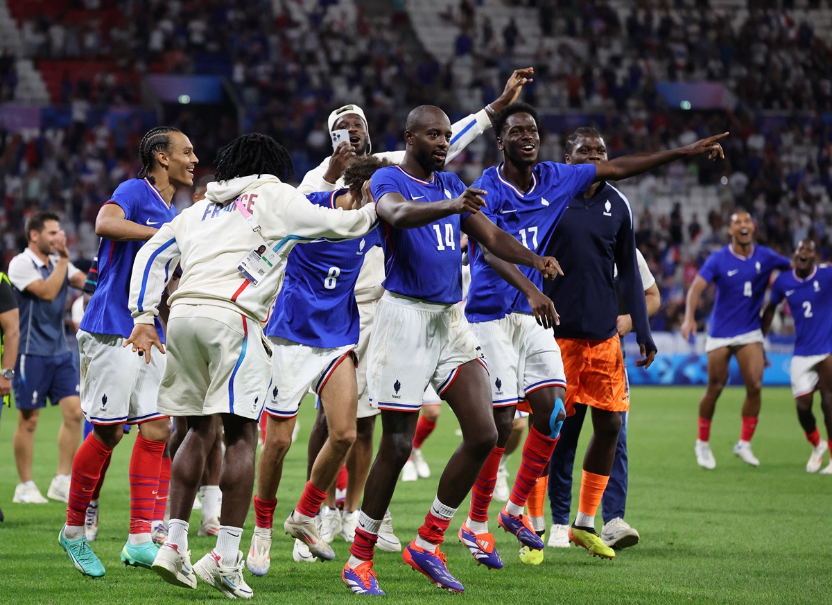 Jean-Philippe Mateta celebrates with teammates Maghnes Akliouche and Soungoutou Magassa after France clinch victory over Egypt in extra-time in the Olympics men's football semi-final at Lyon Stadium, Decines-Charpieu, Paris on Monday night.