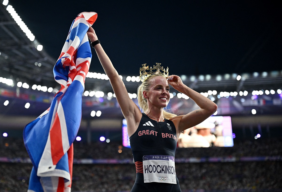 Britain's Keely Hodgkinson celebrates with her National flag and a crown after winning gold women's 800 metres.