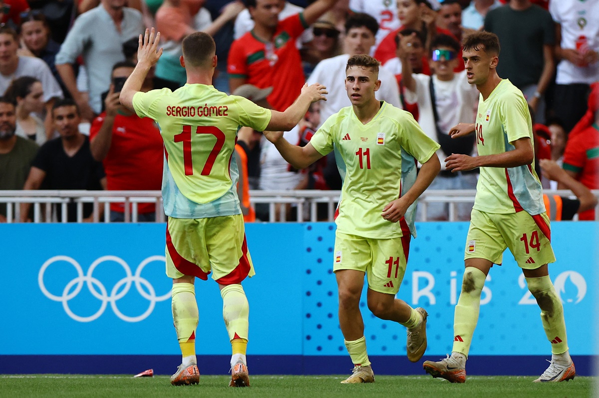 Fermin Lopez celebrates with Sergio Gomez and Aimar Oroz after scoring Spain's first goal. 