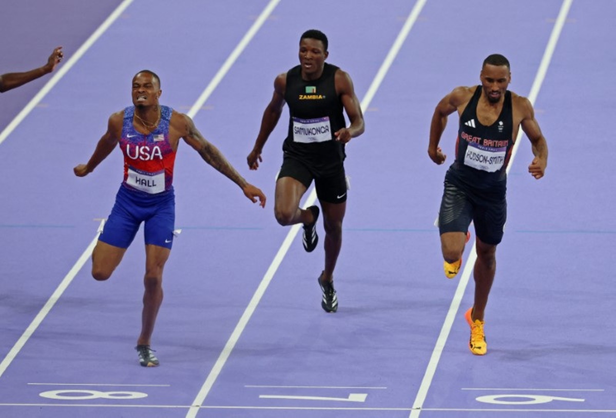 Quincy Hall of United States crosses the line ahead of Britain's Matthew Hudson-Smithto and Zambia's Muzala Samukonga to win the men's 400 metres final.