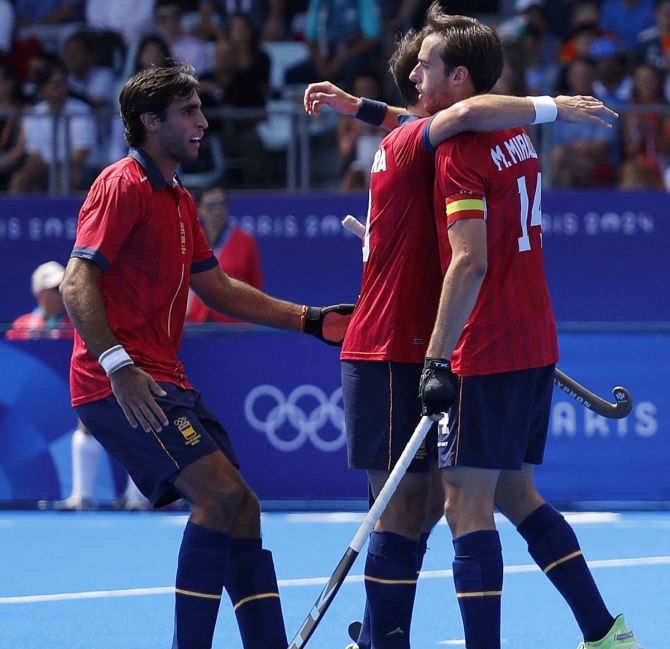 Marc Miralles celebrates with teammates after scoring for Spain. 