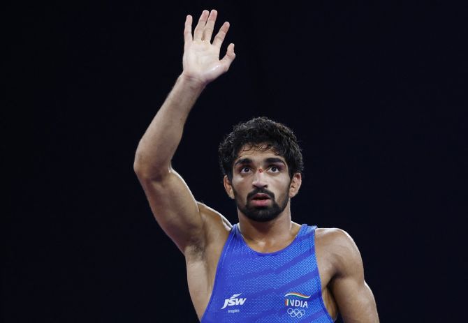 India's Aman Sehrawat celebrates victory over Puerto Rico's Darian Toi Cruz in the Olympics men's Freestyle 57kg wrestling bronze medal bout at the Champ-de-Mars Arena, Paris, on Friday.