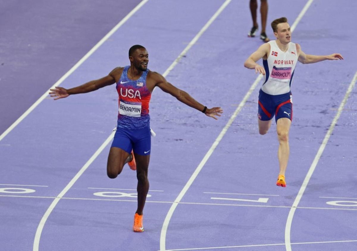 Rai Benjamin of the United States crosses the line ahead of Norway's Karsten Warholm in the men's 400m Hurdles final to win gold.