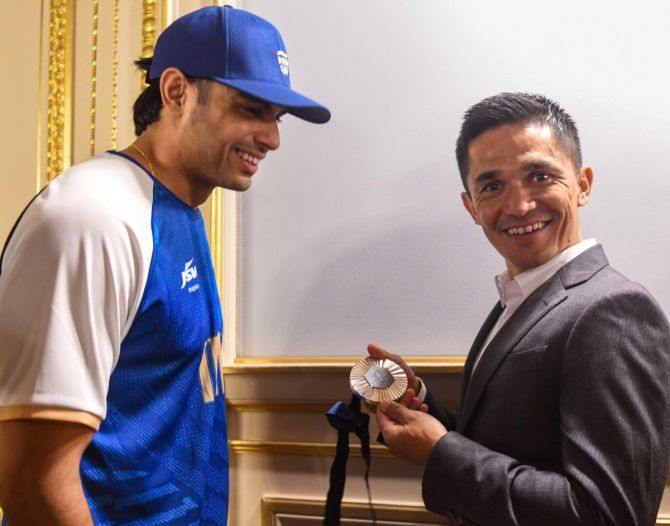 Sunil Chhetri is all smiles as he gets a feel of Neeraj Chopra's Olympic silver medal, in Paris, on Saturday