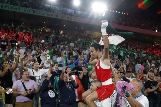 Imane Khelif is carried off the ring after the victory.