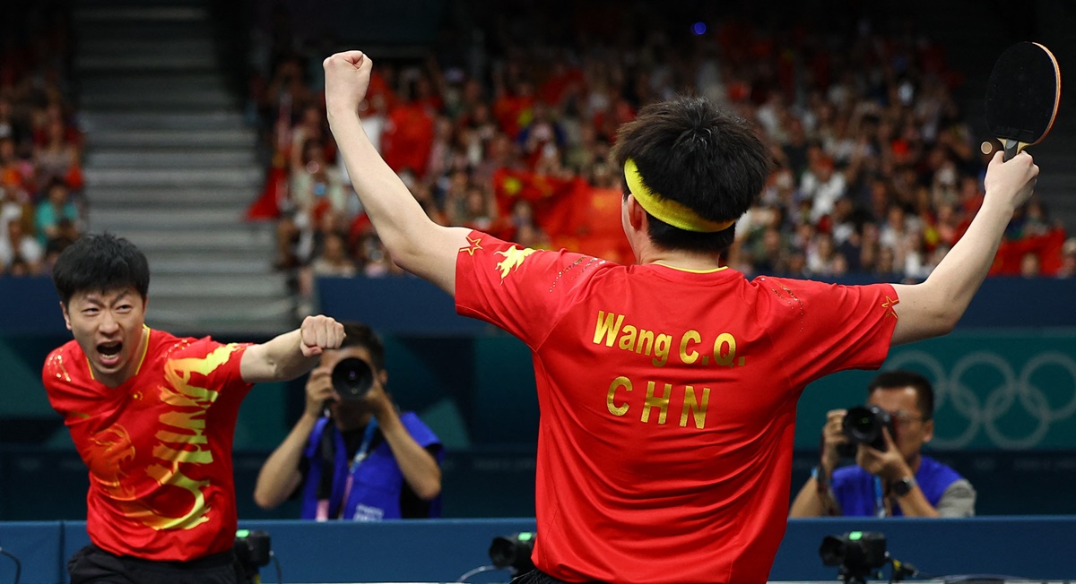 Ma Long reacts after he and Chuqin Wang win the Olympics Table Tennis gold medal match against Sweden's Anton Kallberg and Kristian Karlsson at South Paris Arena 4 on Friday.