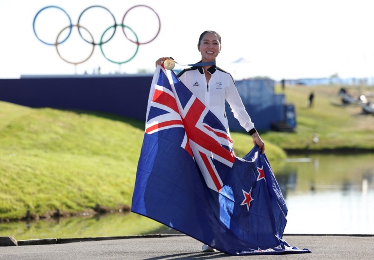 New Zealand's Lydia Ko poses with her medal and national flag as she celebrates winning the Olympics women's golf event at the Le Golf National, Guyancourt, in Paris, on Saturday.