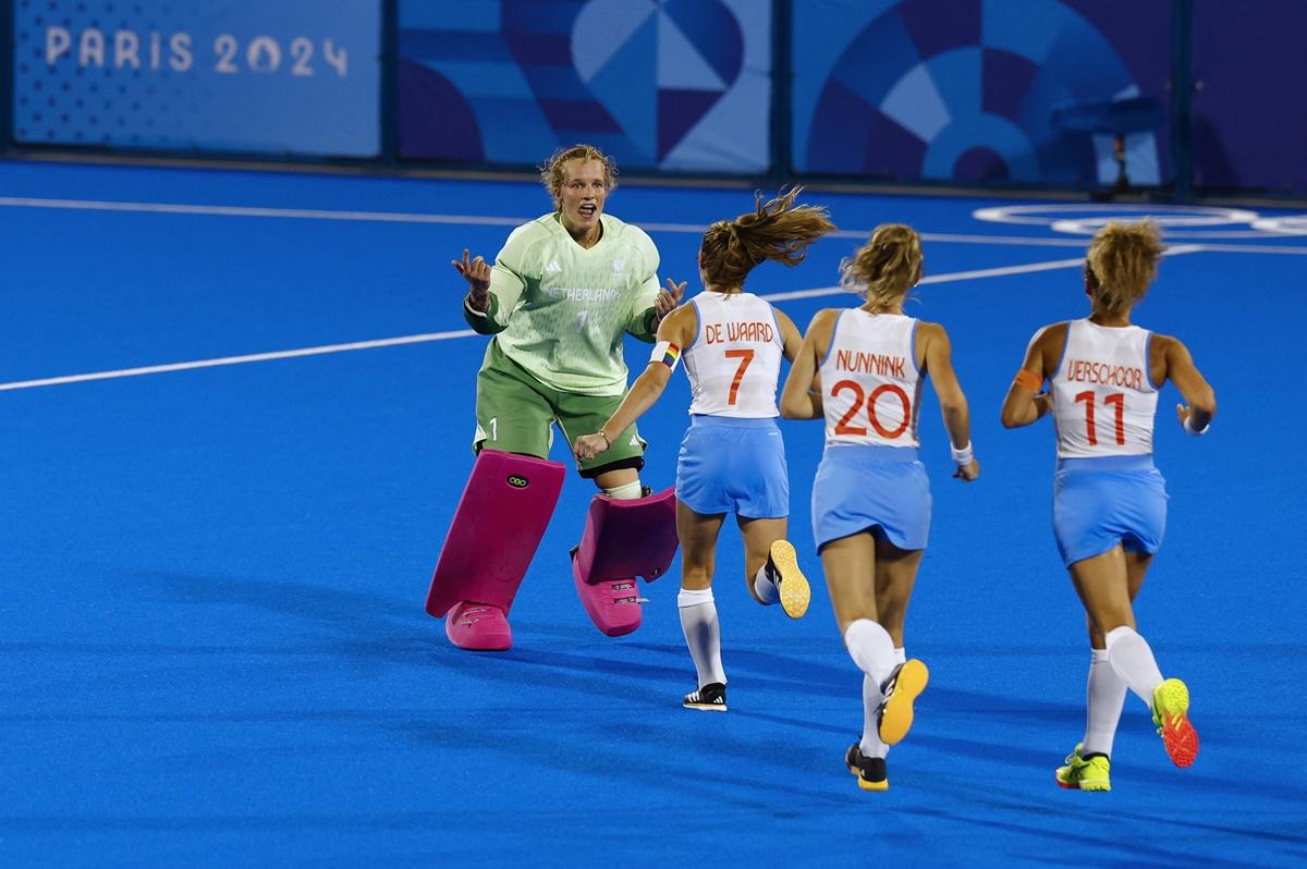 The Netherlands players rush to congratulate goalkeeper Anne Veenendaal after she stops the fourth penalty in the shoot-out from Ma Ning to secure victory.