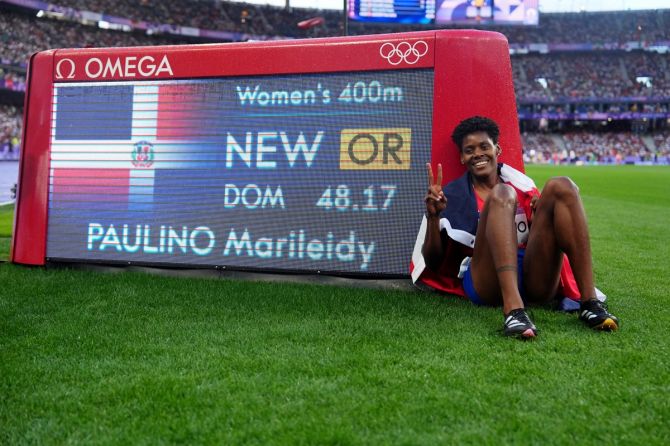 Marileidy Paulino of the Dominican Republic celebrates after winning gold in the women's 400 metres final and setting a new olympic record.