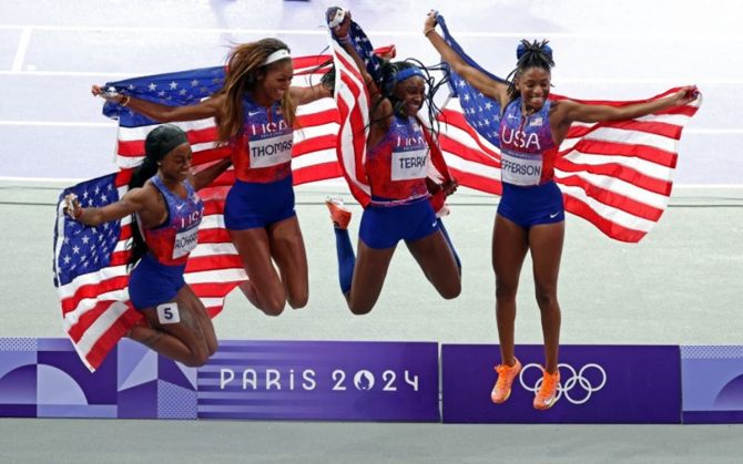 The United States team of Gabrielle Thomas, Sha'Carri Richardson, Twanisha Terry and Melissa Jefferson celebrate after winning gold in the women's 4x100 Relay final.