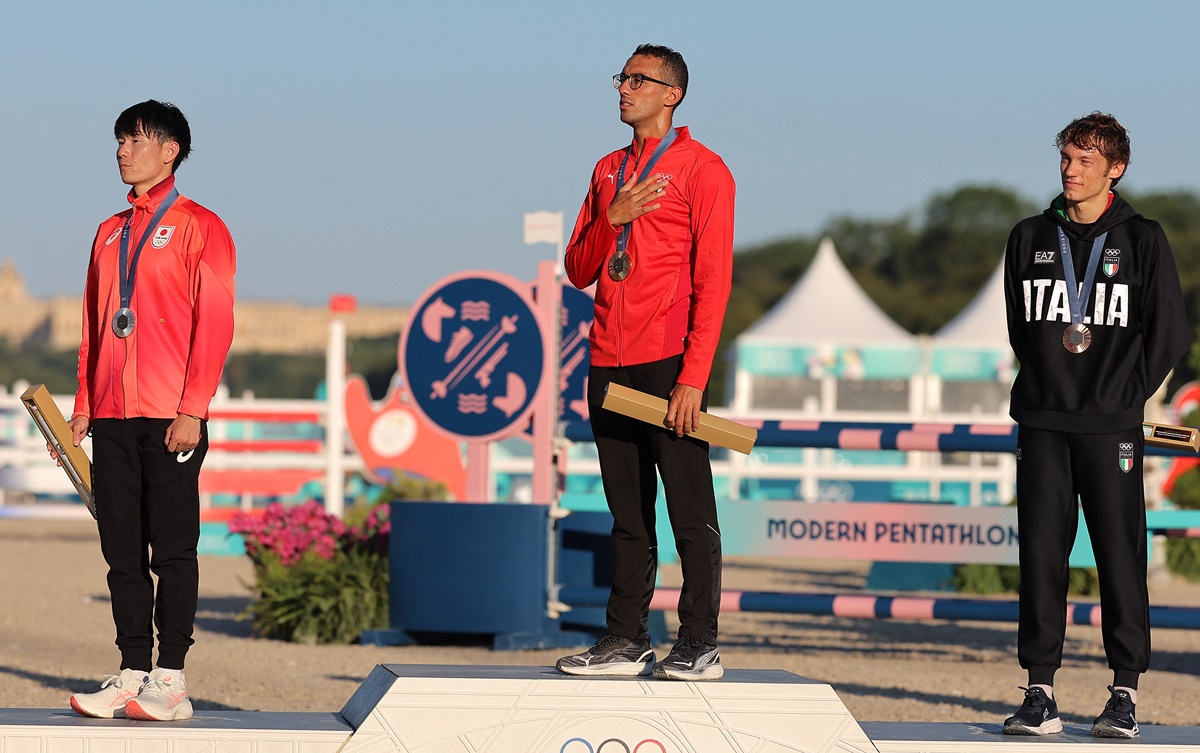 Gold medallist Ahmed Elgendy on the podium with Japan's silver medallist Taishu Sato and Italy's bronze medallist Giorgio Malan.