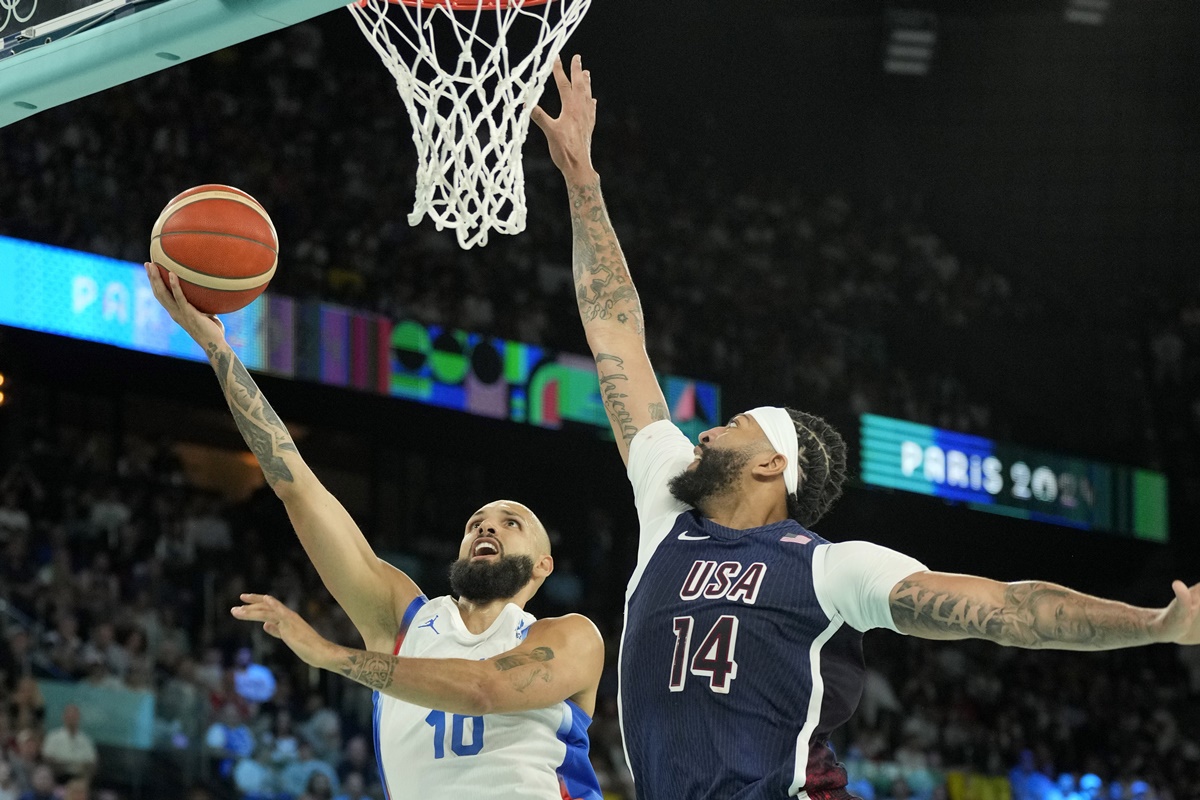 France shooting guard Evan Fournier (10) shoots against United States centre Anthony Davis (14).