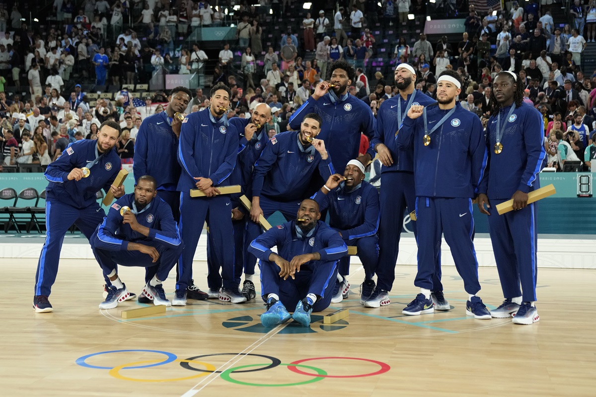 Team USA celebrates with the gold medal after beating France in the Olympics men's final at Accor Arena, Paris, on Saturday.