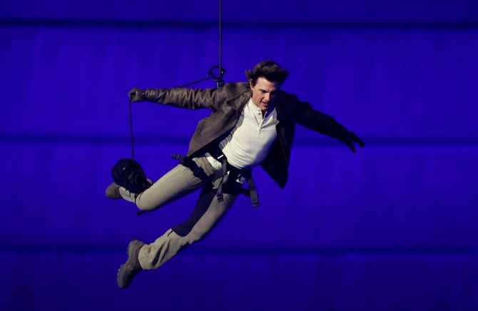 Actor Tom Cruise jumps from the roof of the Stade de France during the Olympics closing ceremony in Paris on Sunday.