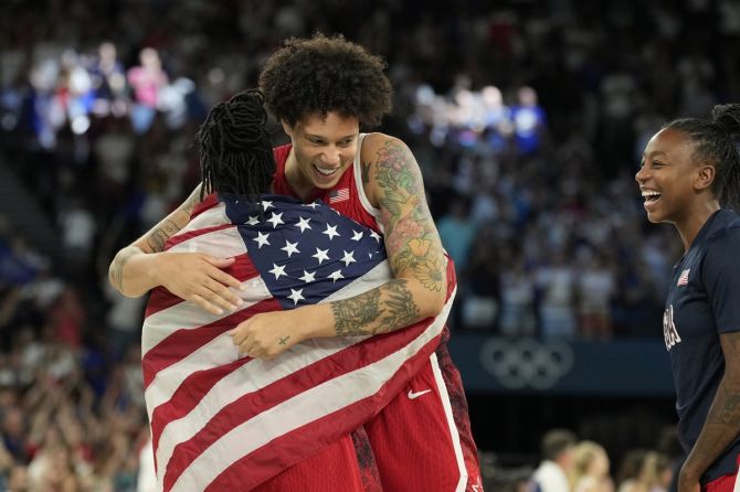 Brittney Griner (15) celebrates with Chelsea Gray (8) after the United States defeat France in the women's gold medal match at the Paris Olympics on Sunday.