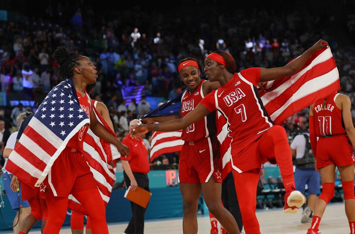 Chelsea Gray, Kahleah Copper and Jackie Young of the United States celebrate after a tense victory over France.