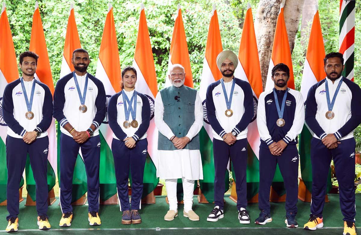 Prime Minister Narendra Modi poses for a group picture with Olympic medalists shooters Manu Bhaker, Sarabjot Singh, Swapnil Kusale, Wrestler Aman Sehrawat, Hockey captain Harmanpreet Singh and goalkeeper PR Sreejesh during his meeting with Indian Contingent of the Paris Olympics 2024, in New Delhi on Thursday.