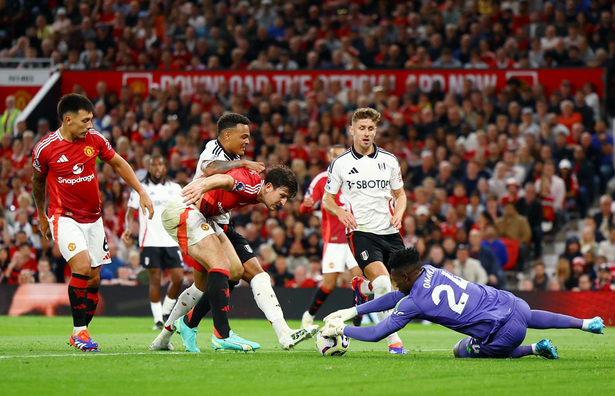 Manchester United's defender Harry Maguire and goalkeeper Andre Onana thwart Fulham's Tom Cairney and Rodrigo Muniz.