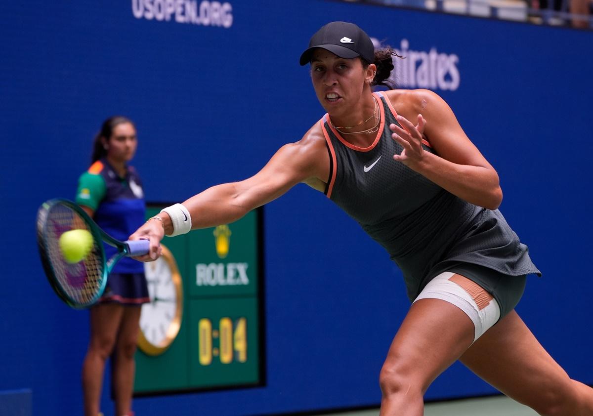 Madison Keys of the United States stretches to return from the baseline against Australia's Maya Joint.