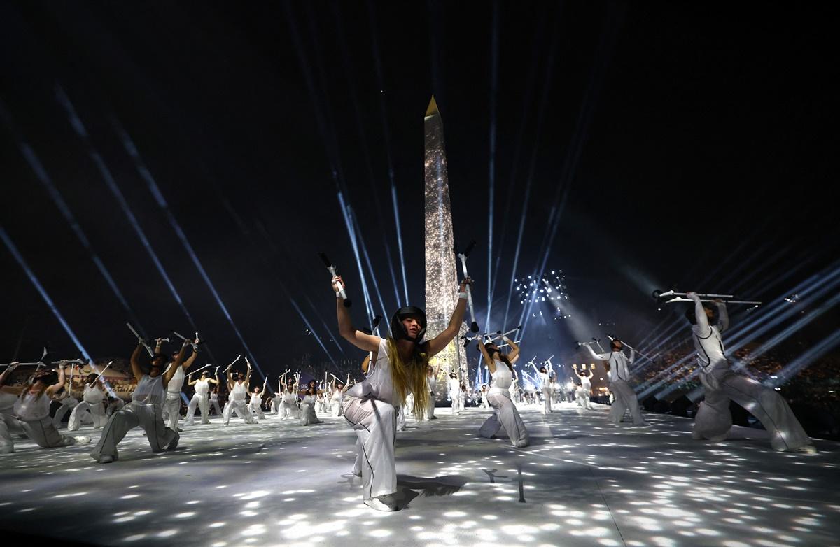 Performers delight as the Obelisk of Luxor on the Place de la Concorde is seen during the 2024 Paralympics Opening Ceremony in Paris on Wednesday.