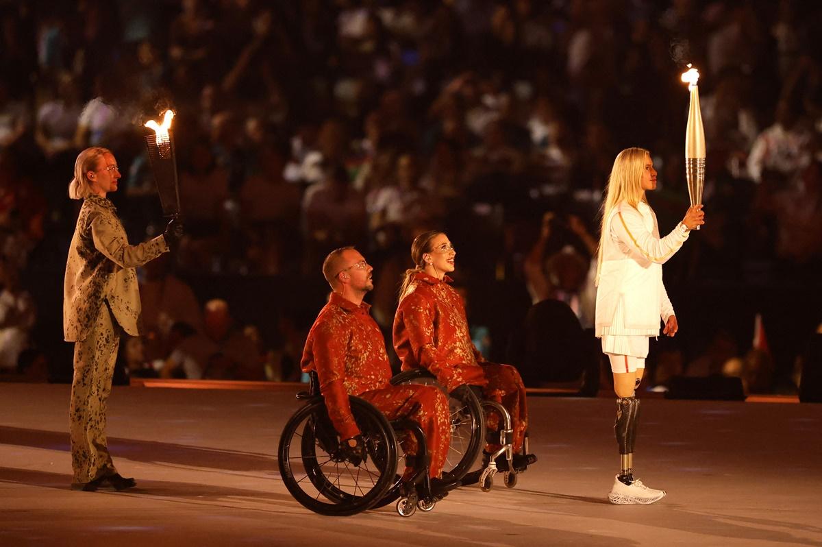 Torchbearer Oksana Masters carries the Paralympic Flame during the opening ceremony.