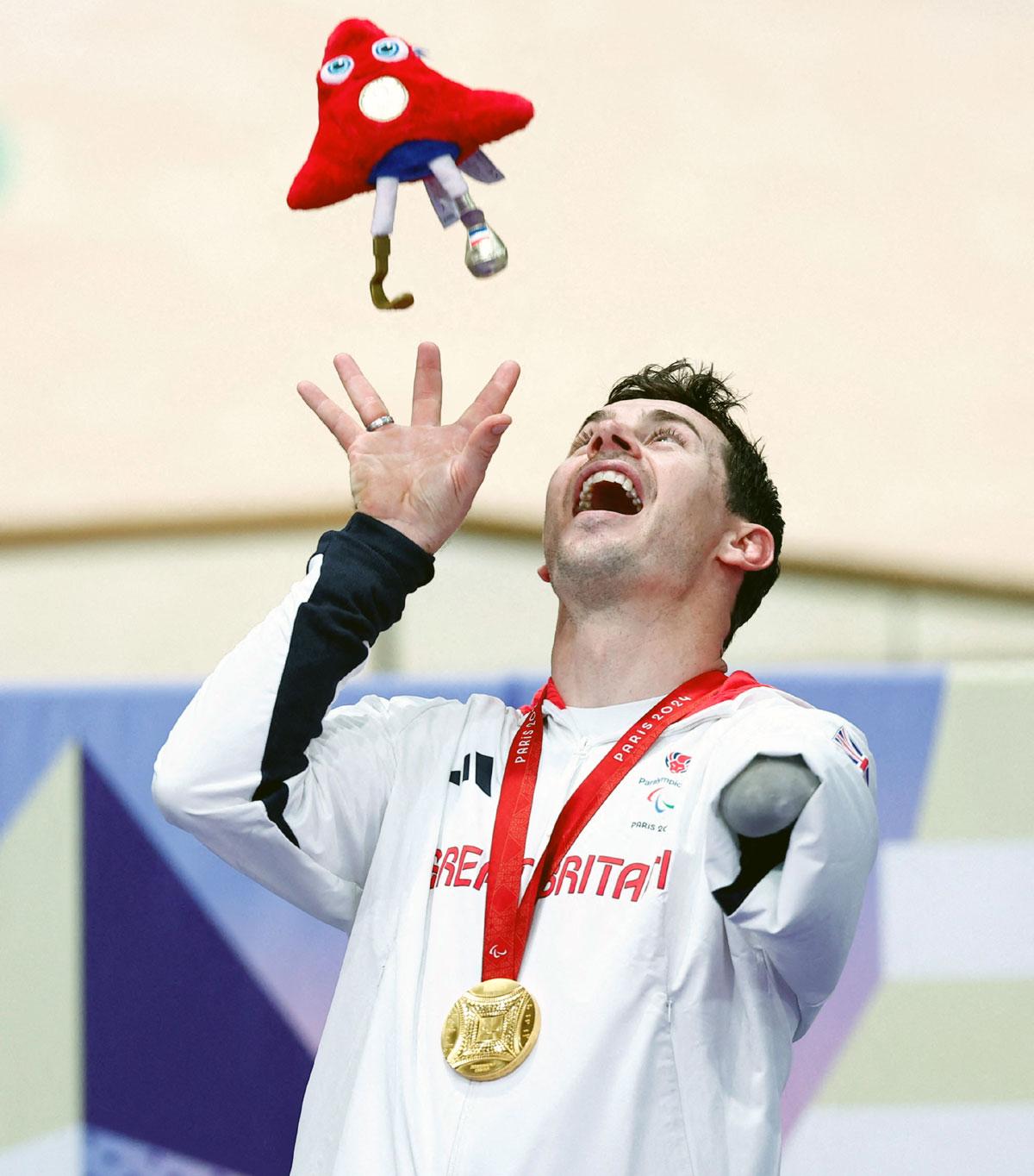 Gold medallist Jaco van Gass of Britain celebrates on the podium