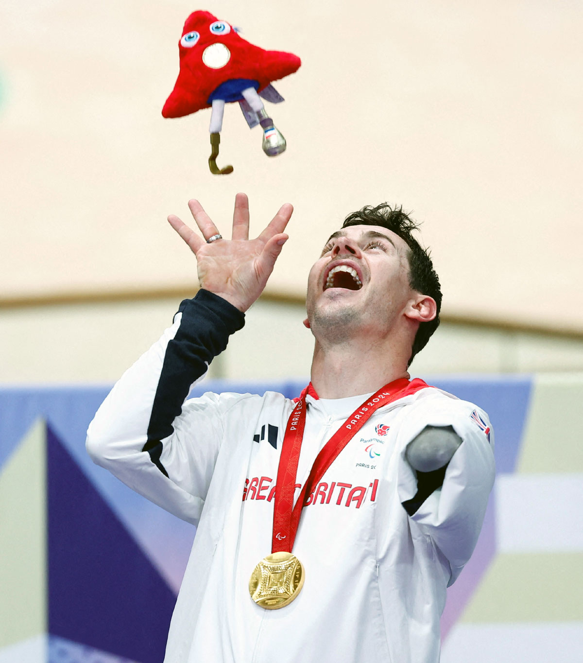 Gold medallist Jaco van Gass of Britain celebrates on the podium