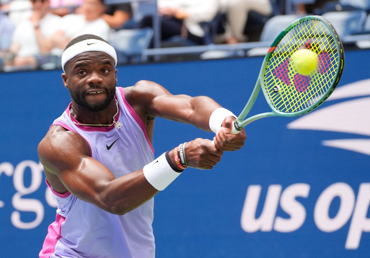 Frances Tiafoe makes a backhand volley.