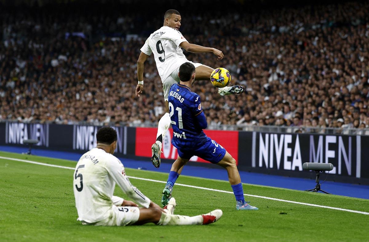 Kylian Mbappe tries to get the ball past Getafe's Juan Iglesias