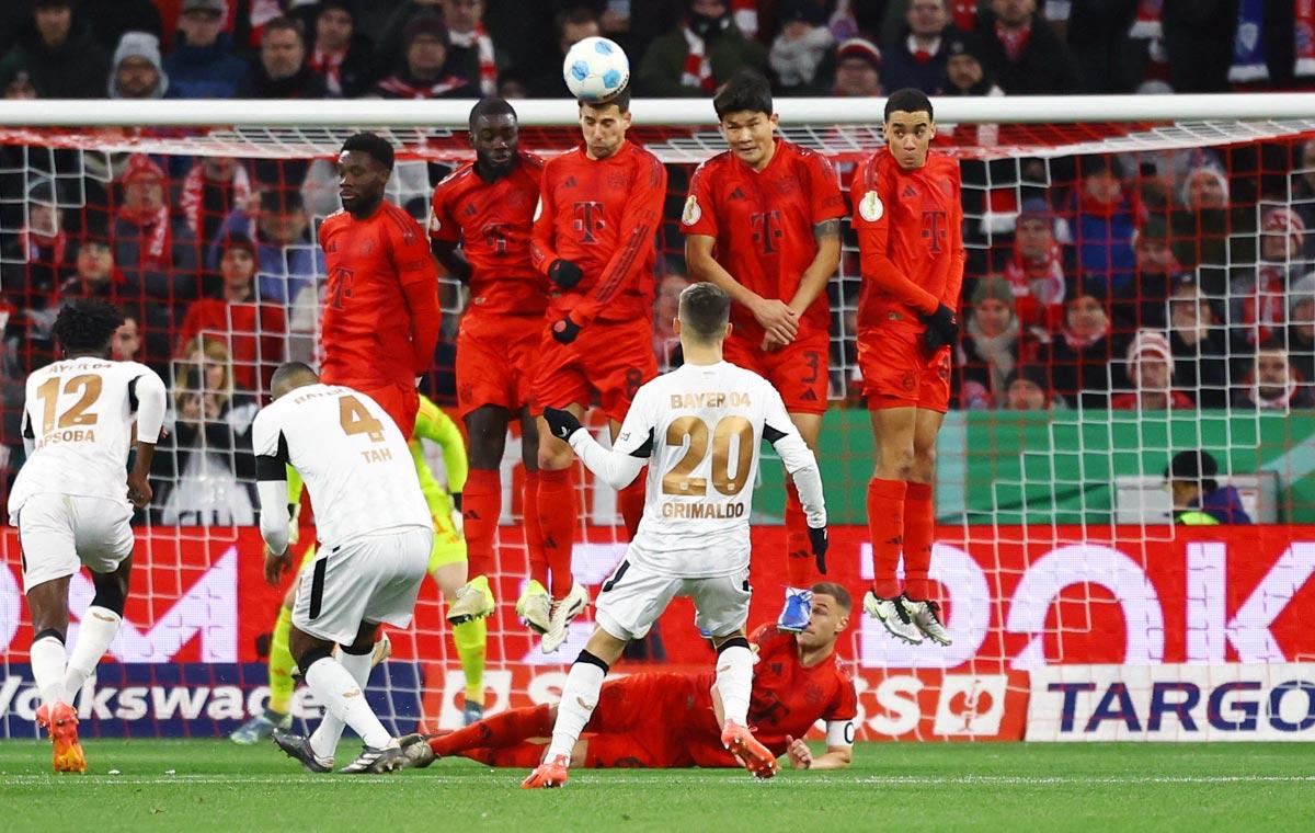 Bayer Leverkusen's Alex Grimaldo takes a free kick