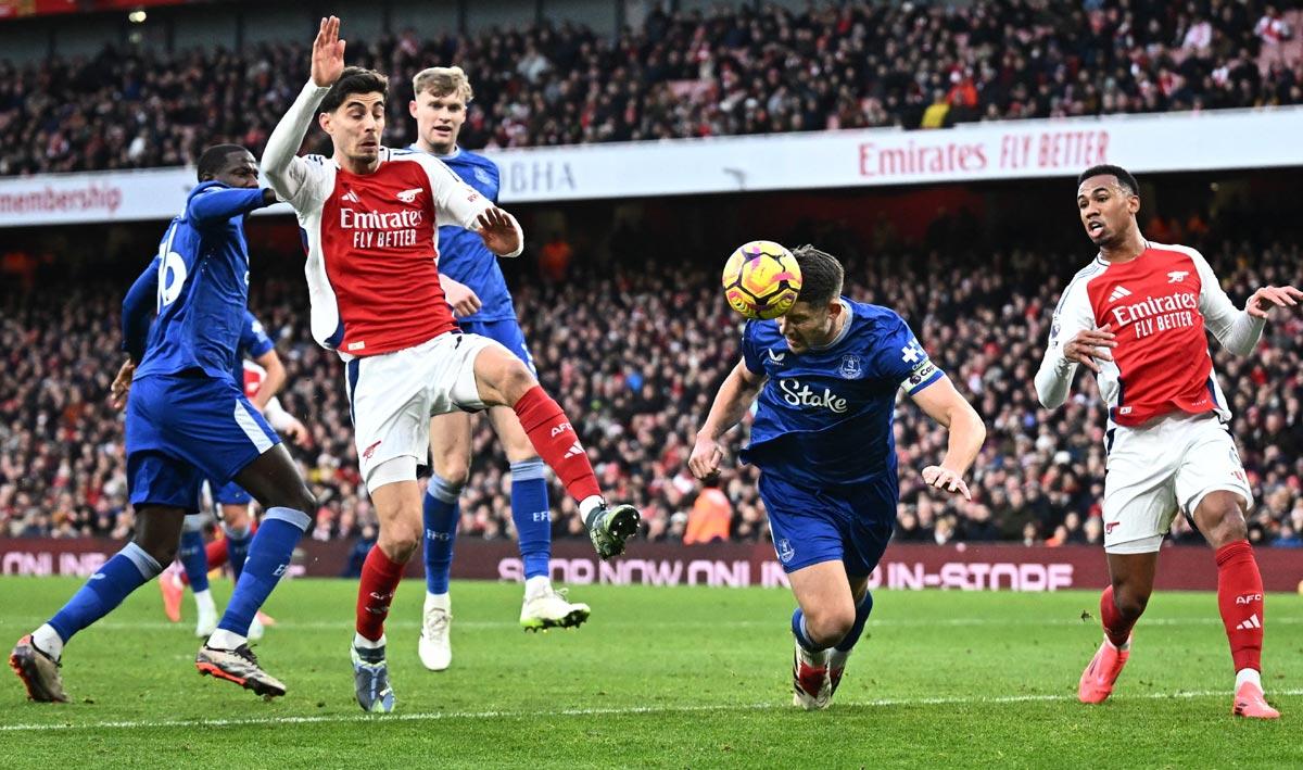 Everton's James Tarkowski clears the shot