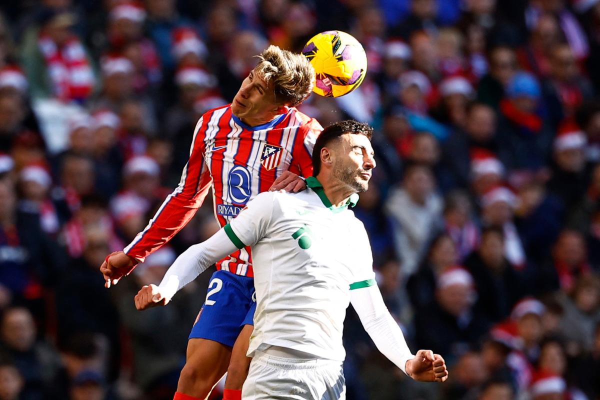 Atletico Madrid's Giuliano Simeone vies for an aerial ball with Getafe's Juan Iglesias