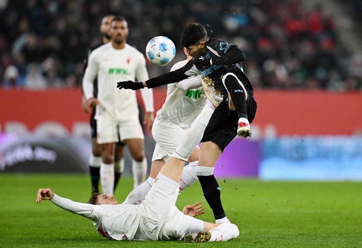 Bayer Leverkusen's Exequiel Palacios tackles Kristijan Jakic