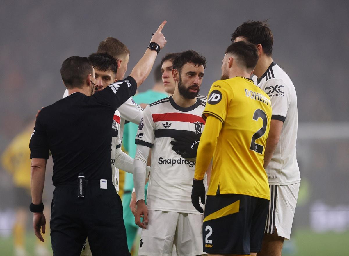 Bruno Fernandes is shown a red card by referee Tony Harrington.