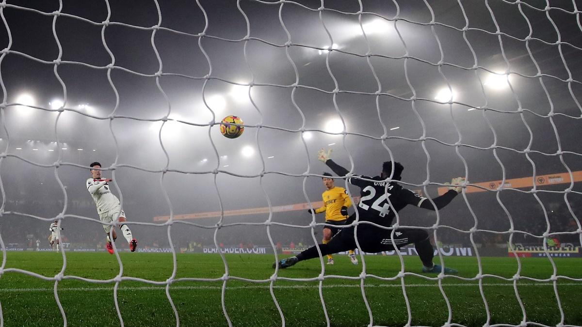 Hwang Hee-chan scores Wolverhampton Wanderers' second goal past Manchester United's Andre Onana at Molineux Stadium, Wolverhampton.