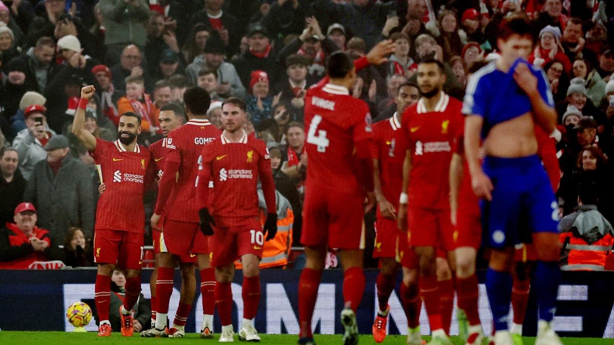 Mohamed Salah celebrates scoring Liverpool's third goal with teammates.